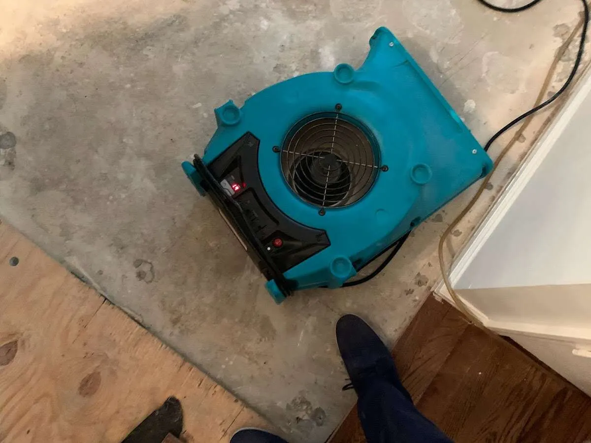 Air mover drying subfloor during Commercial Water Damage Restoration in Gloucester